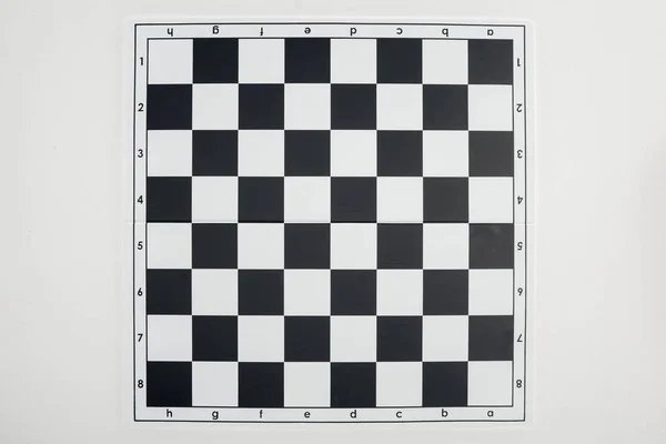 Top view of empty  black and white chessboard on white background — Stock Photo