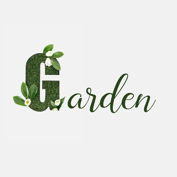Top view of garden lettering with green leaves and flowers isolated on white — Stock Photo