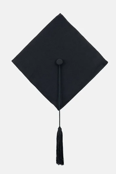 Black academic cap with long tassel isolated on white — Stock Photo