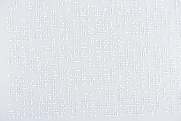 Top view of text in international braille code on white paper — Stock Photo