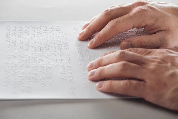 Cropped view of man reading braille text with hands — Stock Photo