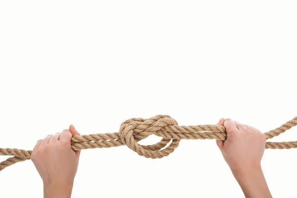 Cropped view of woman holding nautical jute rope with sea knot isolated on white — Stock Photo