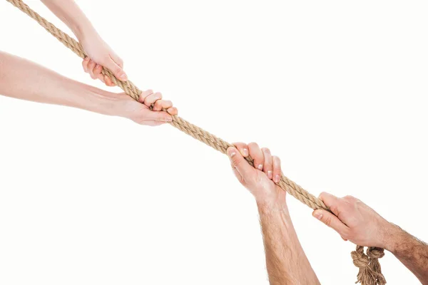 Cropped view of man and woman pulling brown rope isolated on white — Stock Photo