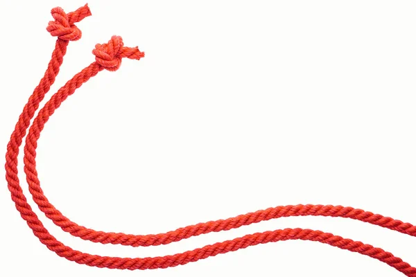 Red long curled ropes with knots isolated on white — Stock Photo