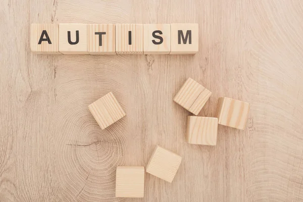 Top view of wooden cubes with autism black lettering on table — Stock Photo