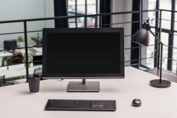 Modern workplace with computer, coffee to go and lamp in office — Stock Photo