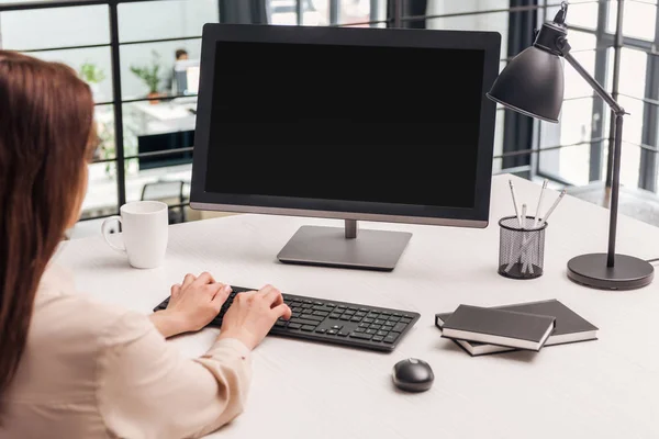 Selective focus of woman using computer at workplace in office — Stock Photo