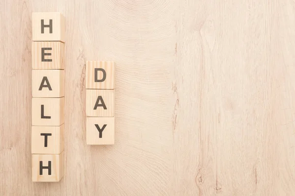 Top view of cubes with health day lettering on wooden background with copy space — Stock Photo