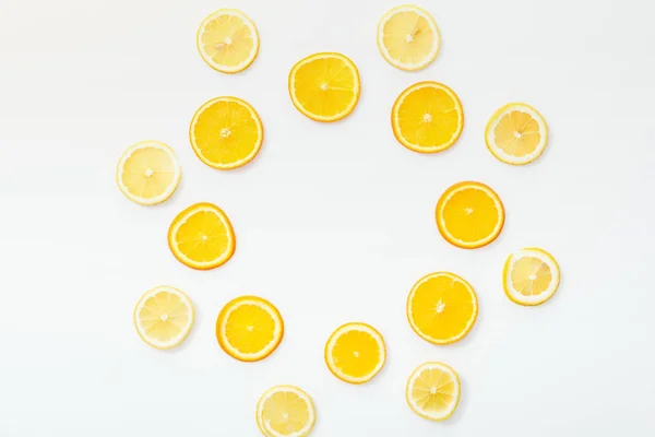 Flat lay with juicy cut fruits on white surface — Stock Photo