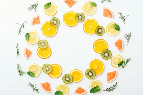 Flat lay with cut fruits and rosemary on white surface — Stock Photo