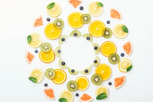 Flat lay with cut fruits and blueberries on white surface — Stock Photo