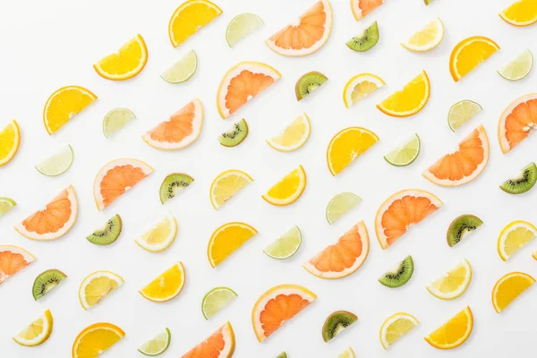 Flat lay with juicy cut fruits on white surface — Stock Photo