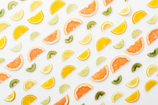 Flat lay with juicy cut fruits on white surface — Stock Photo