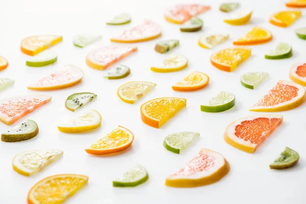 Juicy fresh sliced citrus fruits on white surface — Stock Photo