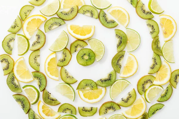 Poser à plat avec des citrons coupés, des citrons verts et des kiwis sur la surface blanche — Photo de stock