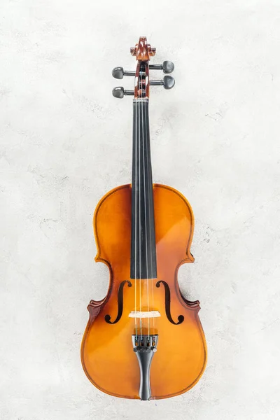 Top view of classical cello on grey textured background — Stock Photo
