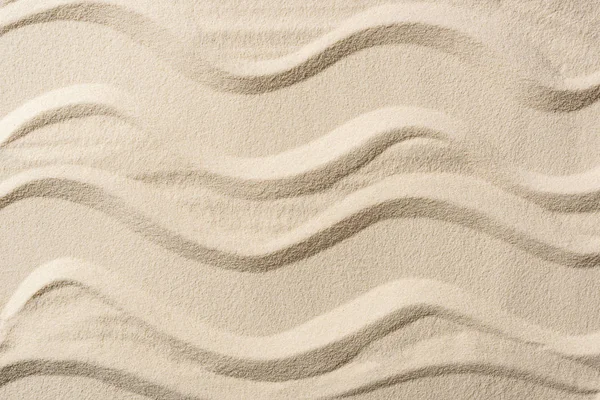 Vue de dessus du fond texturé avec du sable et des lignes lisses — Photo de stock