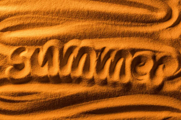 Vue du dessus du mot été écrit dans le sable avec des vagues lisses et filtre de couleur — Photo de stock