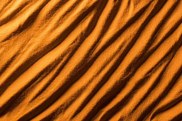 Top view of textured beach sand with waves and orange color filter — Stock Photo