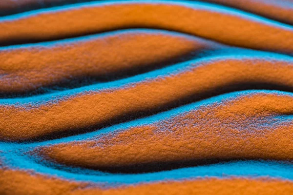Vista de cerca del fondo de arena texturizada con ondas y filtro de color - foto de stock