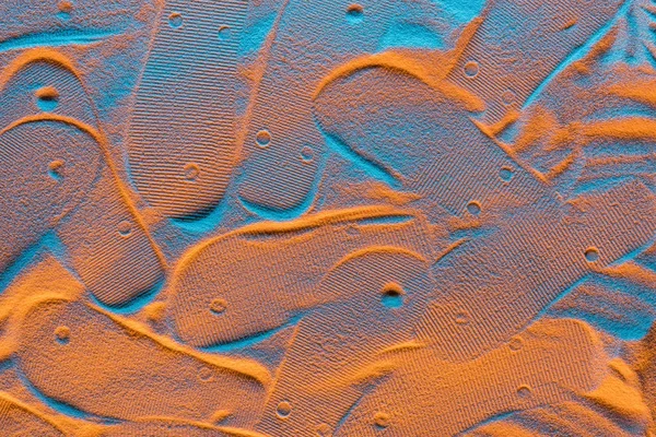 Top view of textured flip flops marks on sand with color filter — Stock Photo