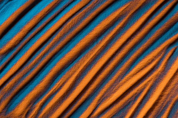 Vue du dessus du fond ondulé abstrait avec sable texturé et filtre de couleur — Photo de stock