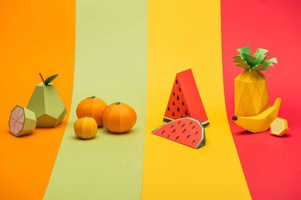 Various handmade origami fruits on stripes of colorful paper — Stock Photo