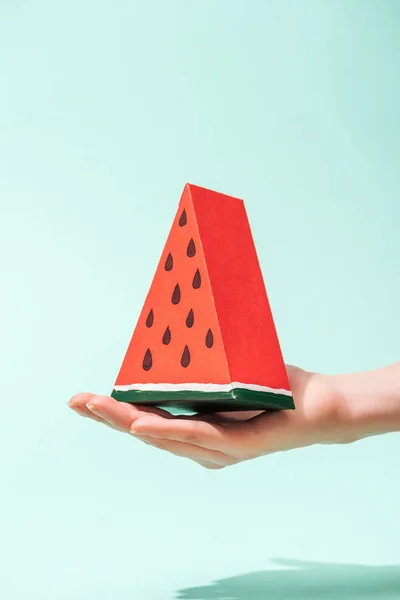 Cropped view of young woman holding handmade paper watermelon on turquoise — Stock Photo