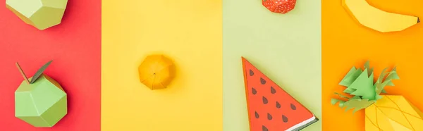 Panoramic shot of various handmade origami fruits on multicolored paper stripes — Stock Photo