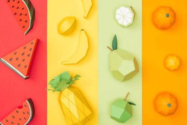 Vista superior de varias frutas de origami hechas a mano en rayas de papel multicolores - foto de stock