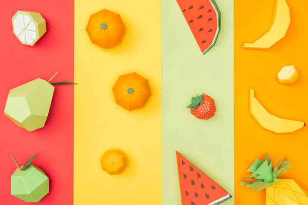 Top view of various handmade origami fruits on multicolored paper stripes — Stock Photo