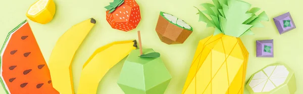 Panoramic shot of colorful handmade paper fruits isolated on green — Stock Photo