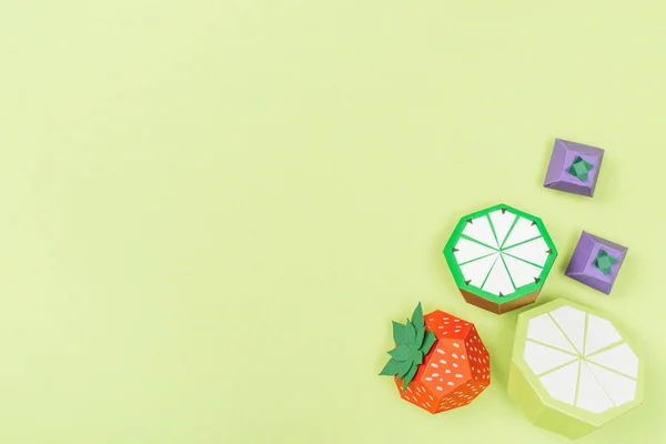 Top view of handmade paper lime, strawberry and lime isolated on green with copy space — Stock Photo