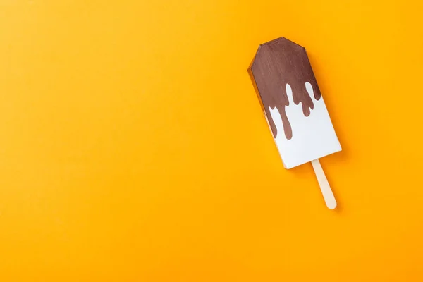 Top view of paper ice cream isolated on orange with copy space — Stock Photo