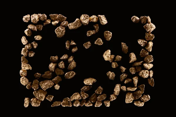 Top view of scattered gold shiny stones isolated on black — Stock Photo