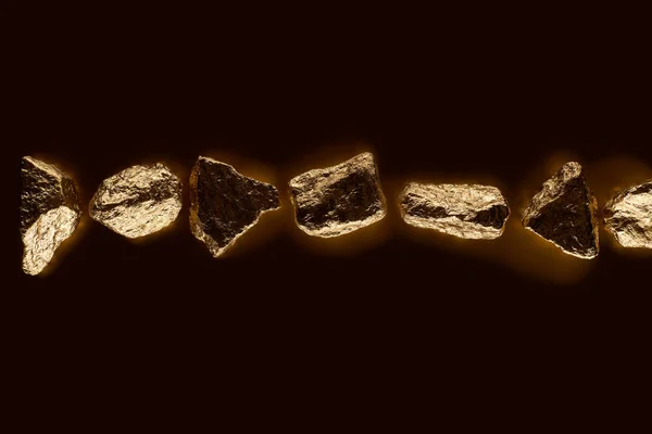 Vista superior de pedras brilhantes douradas em linha isoladas em preto — Fotografia de Stock