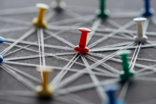 Close up view of push pins connected with strings isolated on grey, network concept — Stock Photo