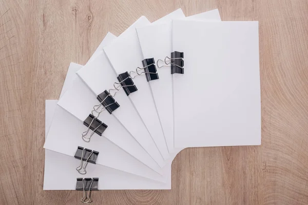 Top view of stacks of blank paper with metal paper clips and copy space on table — Stock Photo