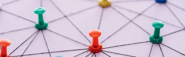 Panoramic shot of push pins connected with strings Isolated On pink, network concept — Stock Photo