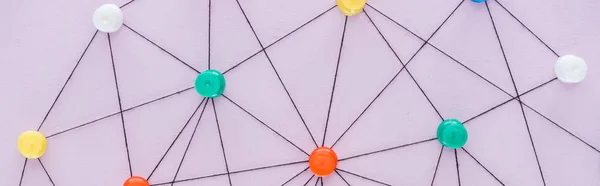 Panoramic shot of colorful push pins connected with strings Isolated On pink, network concept — Stock Photo
