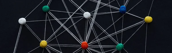 Panoramic shot of push pins connected with strings isolated on black, network concept — Stock Photo