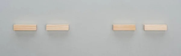 Панорамный снимок деревянных кирпичей, изолированных на сером — стоковое фото
