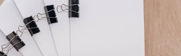 Panoramic shot of stacks of blank paper with metal paper clips and copy space — Stock Photo