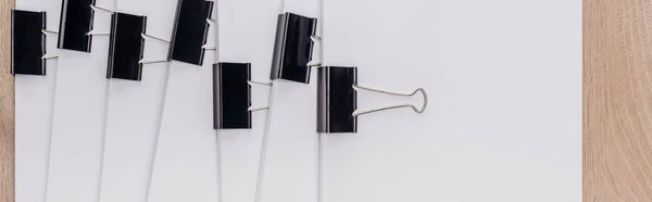 Panoramic shot of stacks of blank paper with metal paper clips — Stock Photo