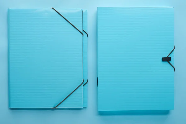 Top view of paper binders isolated on blue — Stock Photo