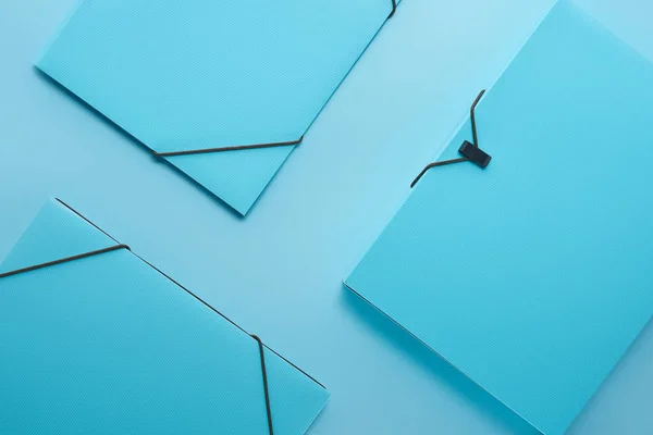 Minimalistic background with paper binders isolated on blue — Stock Photo
