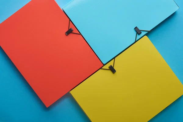 Top view of arranged colorful paper folders on blue — Stock Photo