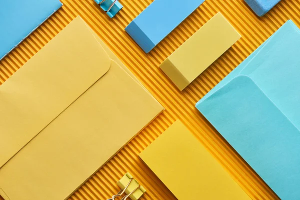 Top view of sticky notes, envelopes and erasers on yellow — Stock Photo