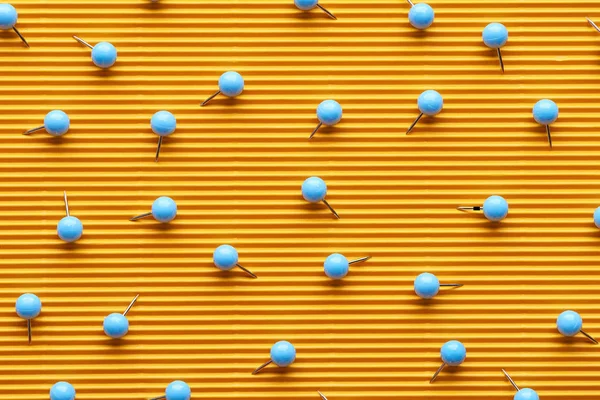 Top view of push pins on textured yellow paper — Stock Photo