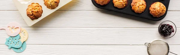 Top view of delicious cupcakes and baking tools on wooden table with copy space — Stock Photo